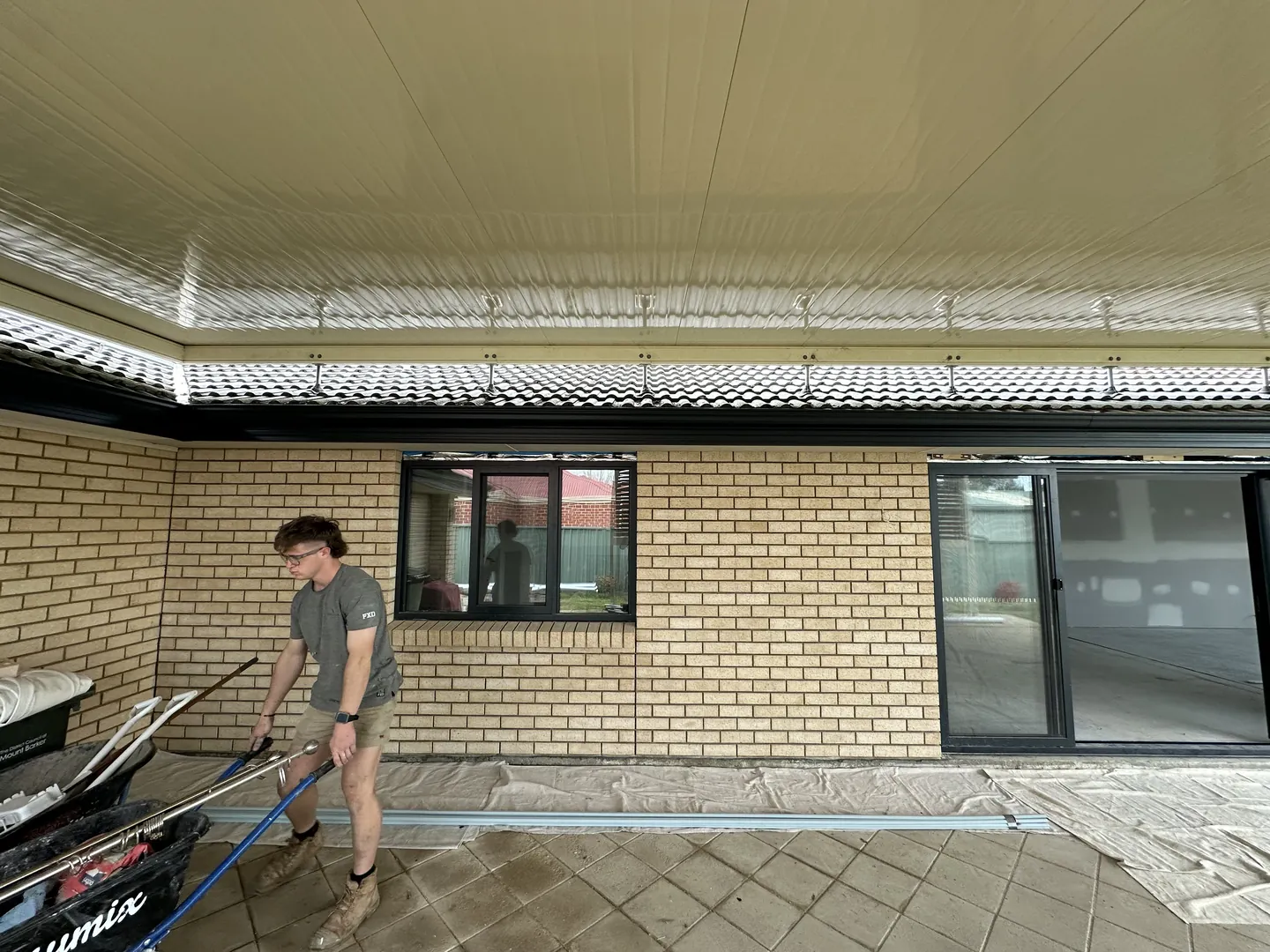 Person working on patio construction with tools.
