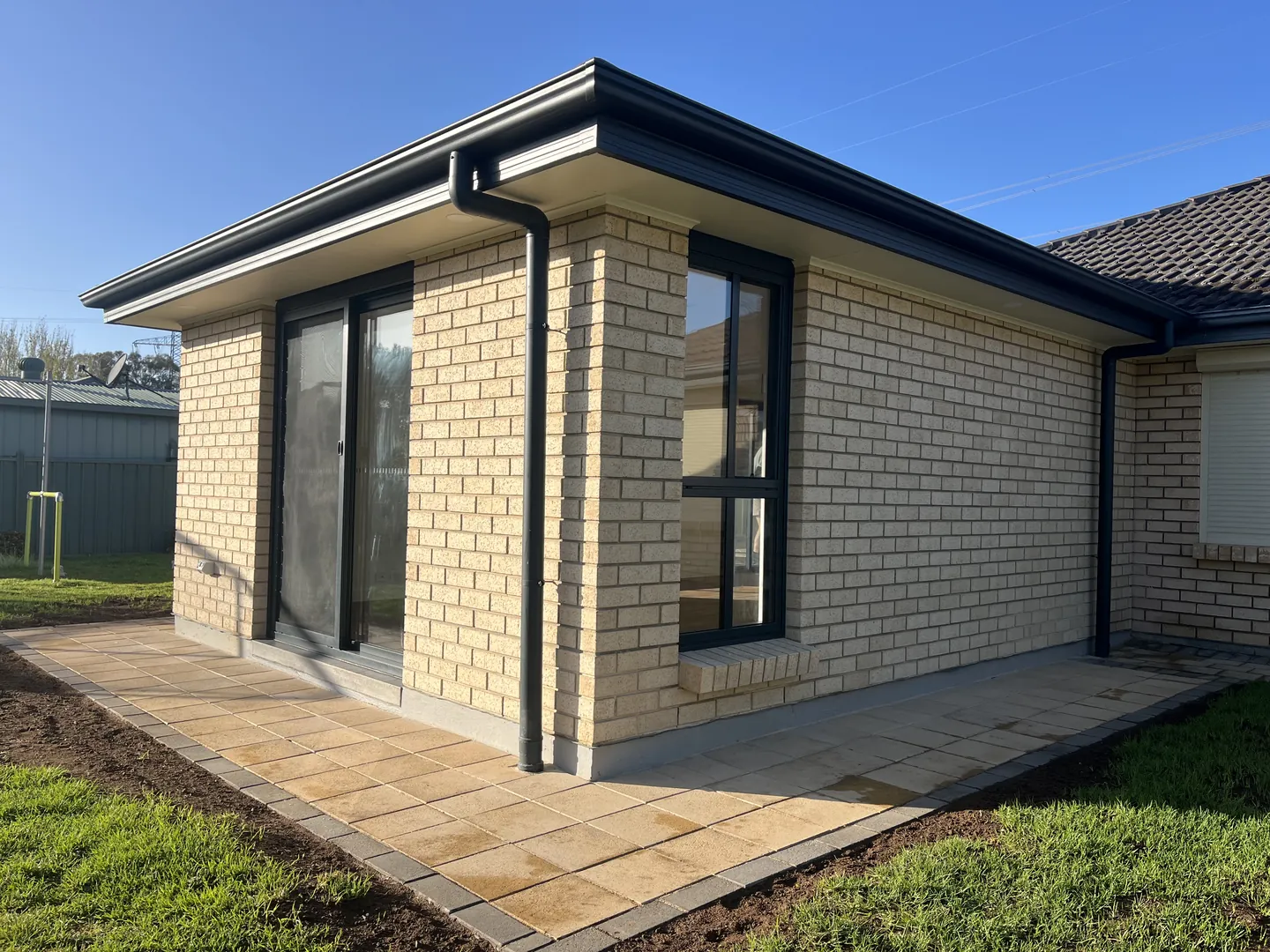 Modern brick house with patio and glass doors.